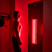 Model Standing Using Panel from Home -Bestqool Pro200 Full-Body Red Light Therapy Panel-4 Wavelengths for Advanced Treatment
