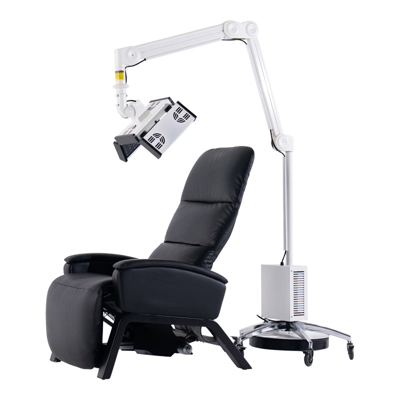 ApolloGlow facial red light therapy panel mounted on adjustable arm positioned over a reclining treatment chair on white background