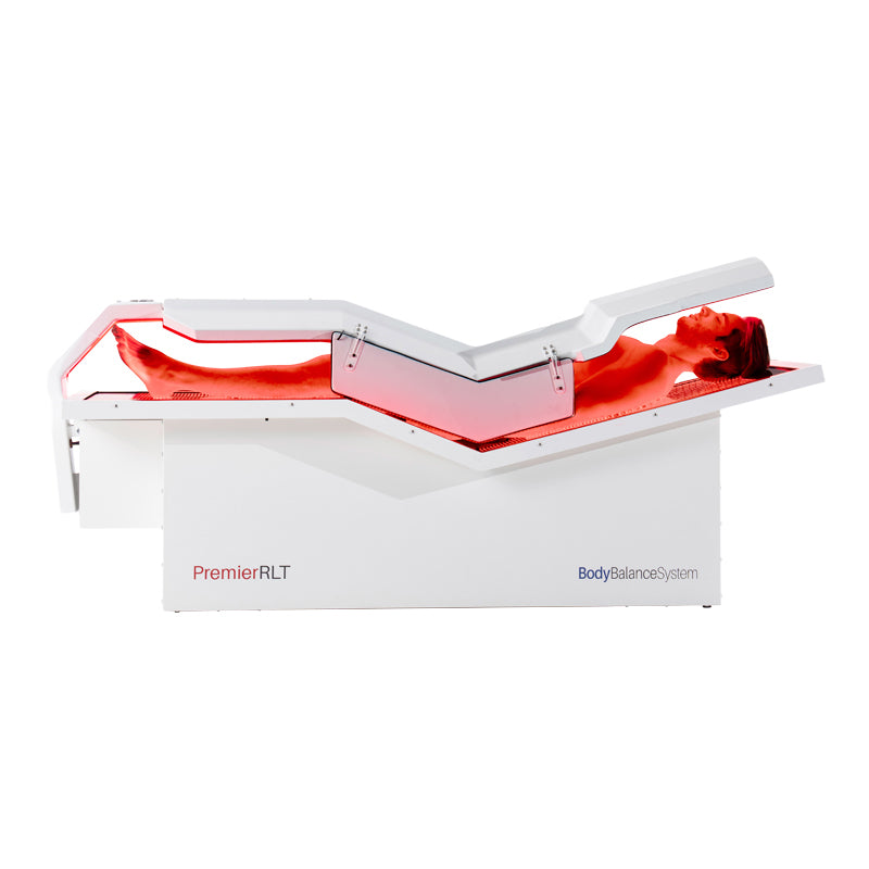 Man demonstrating Body Balance System PremierRLT laying down with canopy closed powered on side profile on a white background