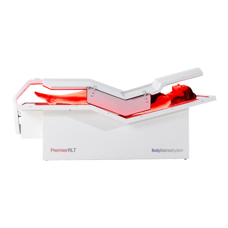 Woman demonstrating Body Balance System PremierRLT laying down with canopy closed powered on side profile on a white background