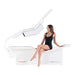 Woman sitting in Body Balance System PremierRLT zero gravity red light therapy bed side profile with canopy open on white background
