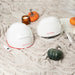 Two iRestore Essential Laser Hair Growth System helmets in festive fall or Thanksgiving-themed background
