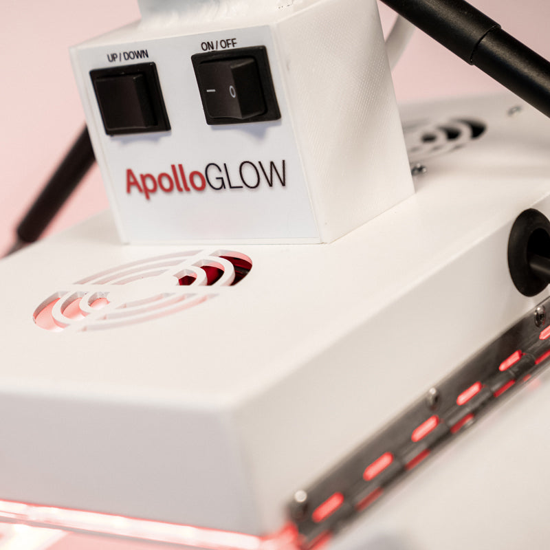 Close-up of the ApolloGlow facial red light therapy panel showing control switches and LED array