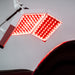 ApolloGlow facial red light therapy device with triple LED panels illuminated for targeted skin treatment.