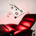 ApolloGlow red light therapy system positioned over reclining chair for full-body treatment