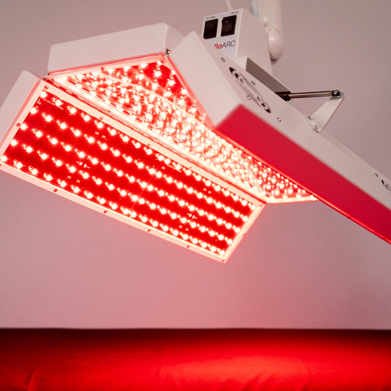 Angled view of the Body Balance System ApolloARC with hinged LED panels illuminated