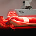 Female model receiving treatment from the body balance system ApolloARC red light therapy panel with illuminated side LED panel