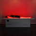 Female lying flat on Body Balance System OvationLITE red light therapy bed with full-body LED illumination