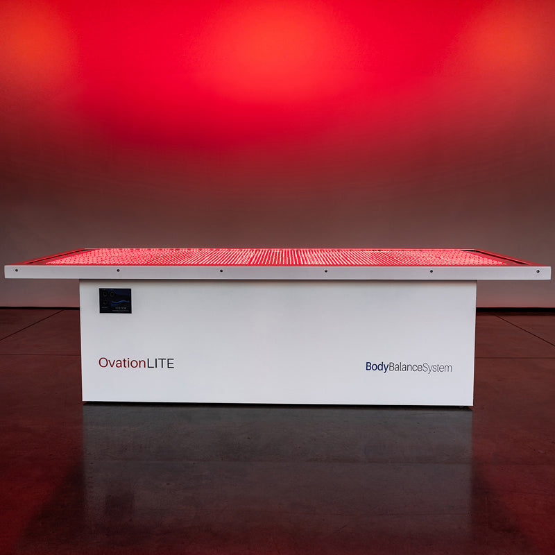 Body Balance System OvationLITE red light therapy bed with LEDs illuminated, product side view