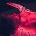 Body Balance System OvationULT Red Light Therapy Bed – close-up of male model’s upper body and face during infrared light treatment in dark room, highlighting red glow and full-body recovery benefits.