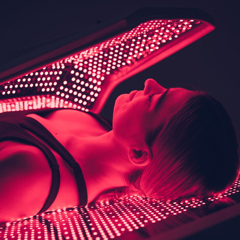 Body Balance System Ovation ULT powered on in use with female model zoomed into upper body and face for a whole body relight treatment