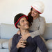 male and female couple in the comfort of their own home both receiving treatment from the iRestore Professional laser hair growth helmet.